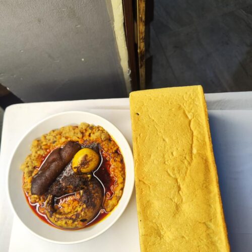 Ewa agoyin with round fish, egg and kponmo and bread